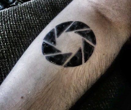 The article said this was a perfect tattoo if you were a photographer, I  could only picture the aperture science logo. : r/Portal